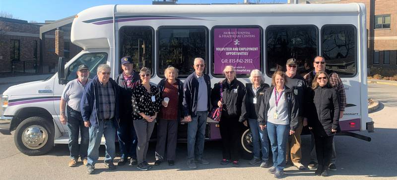 Morris Hospital patient transportation volunteers gather for a photo to celebrate the service’s 25th anniversary.