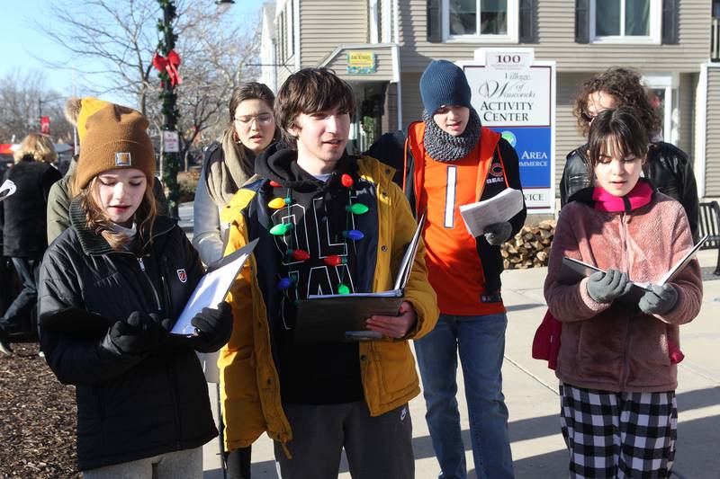 A group of members of all choirs from Wauconda High School sing Christmas carols during Holiday Walk on Main in Wauconda. The event was sponsored by the Wauconda Area Chamber of Commerce.