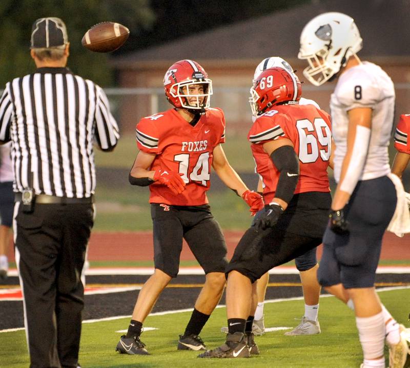 Yorkville wide receiver Eli Walston (14) celebrates a touchdown catch with teammates during a varsity football game at Yorkville High School on Friday, Sep. 1, 2023.