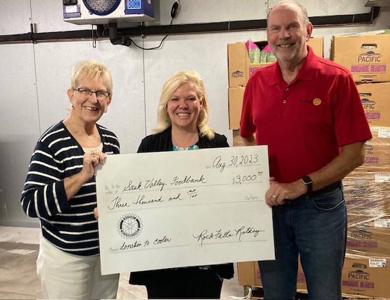 Pam Martinez, Executive Director of Sauk Valley Foodbank, center, accepts a check for $3,000 from Rock Falls Rotarians, Betty Clementz, grant chair, and Bob Sondgeroth, president, to support the purchase of the newest cooler to keep perishables from spoiling until distribution can take place.