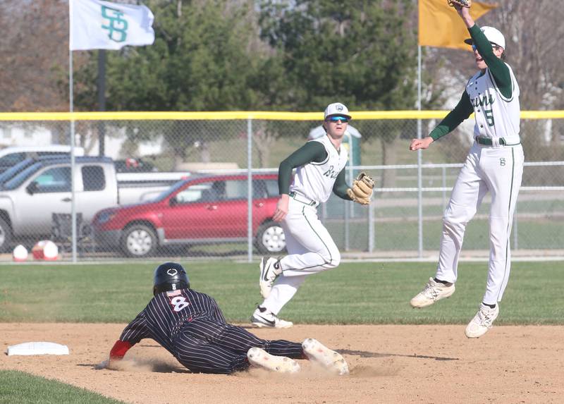 Hall's Braden Curran steals second base as St. Bede's Sturart McGunnigal leaps in the air to catch a late throw while teammate Gus Burr watches from the back of the infield on Monday, March 31, 2025 at Schweickert Stadium in Peru.