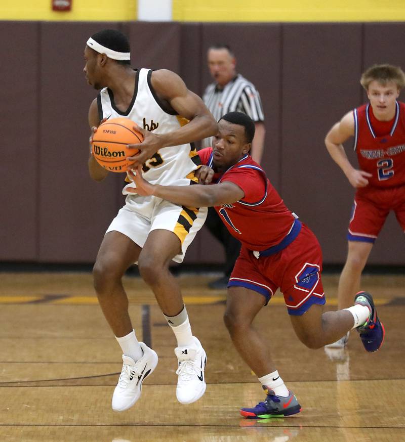Dundee-Crown's Kadin Malone (right) tries postal the ball from Jacobs' Elijah Bell during a Fox Valley Conference boys basketball game on Tuesday, February. 3, 2026, at Jacobs High School in Algonquin.