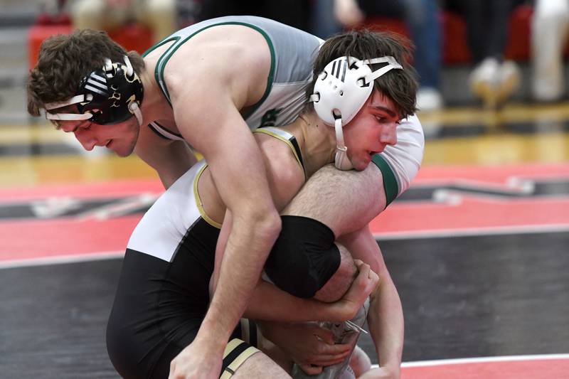 Polo's Kaenyn McCarren grabs the leg of  West Carroll's Cole Herrell as they wrestle for first place in the 150-pound division at the 1A Stillman Valley Sectional on Saturday, Jan. 31, 2026 at Stillman Valley High School.