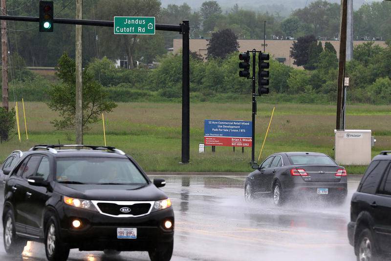 Vehicles drive by the intersection Tuesday of Jandus Cutoff Road and Route 14, where a gas station is proposed to be built south of the intersection in Cary.