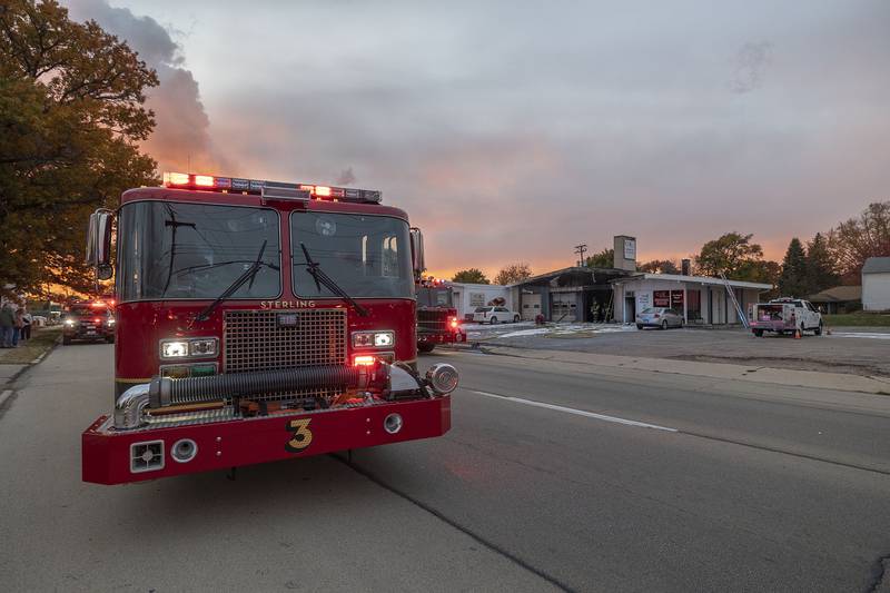 Firefighters work at 1812 E. Fourth St. in Sterling on Friday, Nov. 7, 2025, during a building fire at C&K Undercar Specialists.