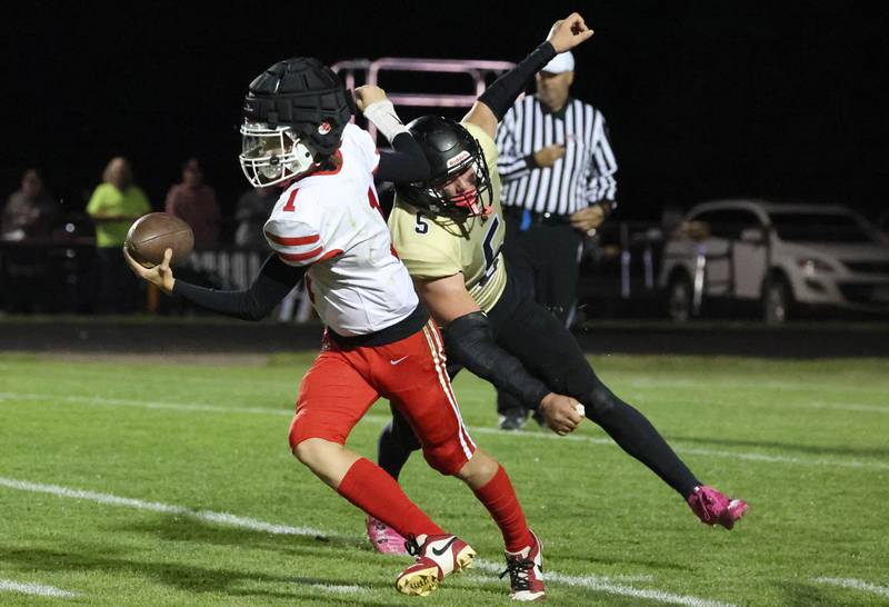 Ottawa’s Mark Munson avoids the pressure of Sycamore's Kyle Prebil during their game Friday, Sept. 27, 2024, at Sycamore High School.