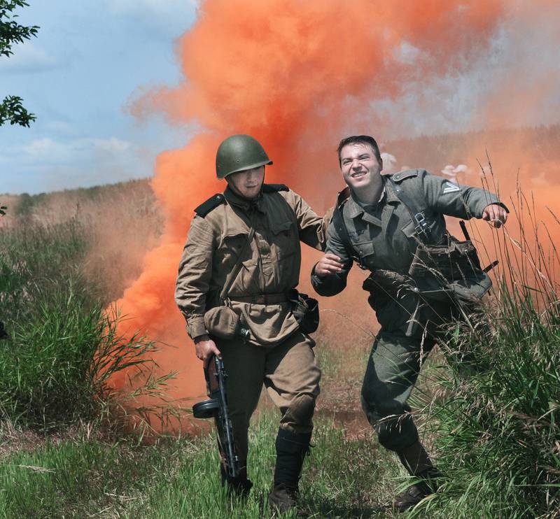 A soldier is taken prisoner, though later shot, during a mock World War ll battle Saturday, July 15, 2023, during the fourth annual Ottawa Military Show, north of Ottawa. Military displays and vehicles which the public could ride and a parade through Ottawa were part of the weekend event.