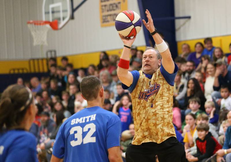 Logan Junior High students success mentor Tim Carrasca, (The Candy Man) takes a shot over superintendent Tim Smith during the Harlem Wizards event on Tuesday, Oct. 28, 2025 in Pannebaker Gymnasium at Logan Jr. High School in Princeton.