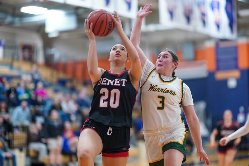 Benet’s Emma Briggs (20) drives to the hoop against Waubonsie Valley's Maya Cobb (3) during a Class 4A Oswego Sectional final basketball game at Oswego High School on Thursday, Feb 22, 2024.