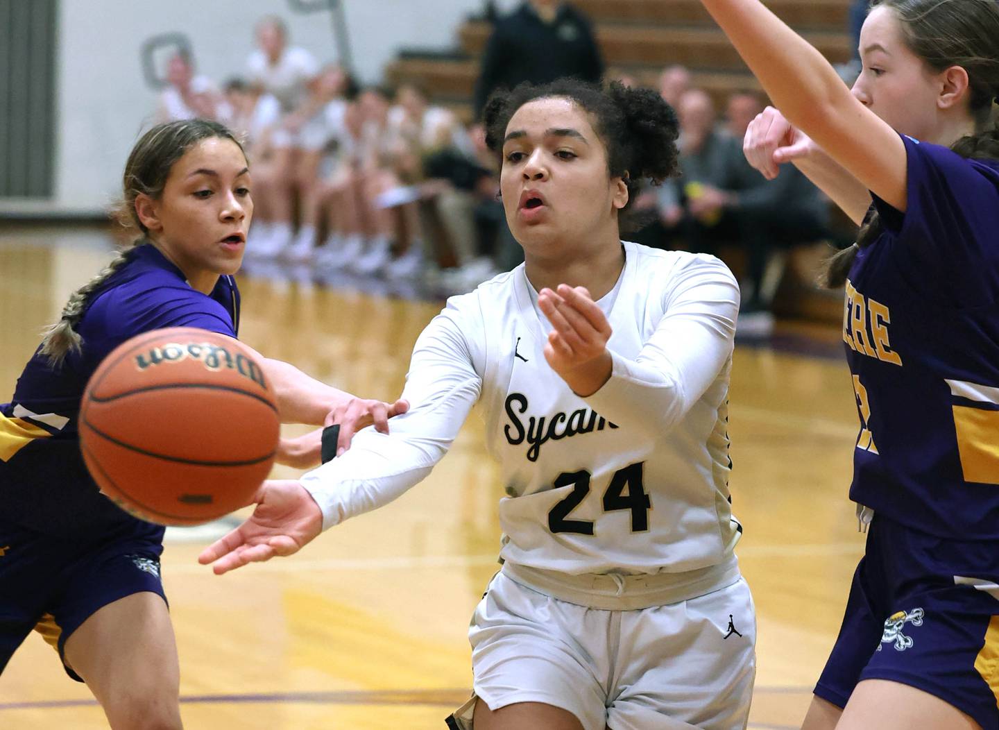 Sycamore's Monroe McGhee passes the ball out of a Belvidere double team Friday, Feb 16, 2024, during their Class 3A regional final game at Belvidere High School.