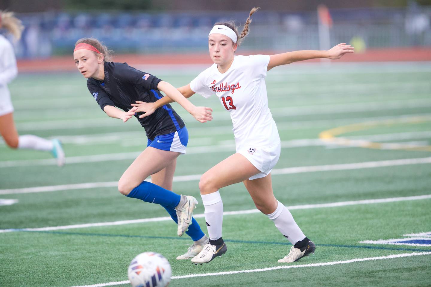 St. Charles North's Kayla Floyd battles for the ball with Batavia's Abi Edwards on Thursday April 11, 2024 in St. Charles.