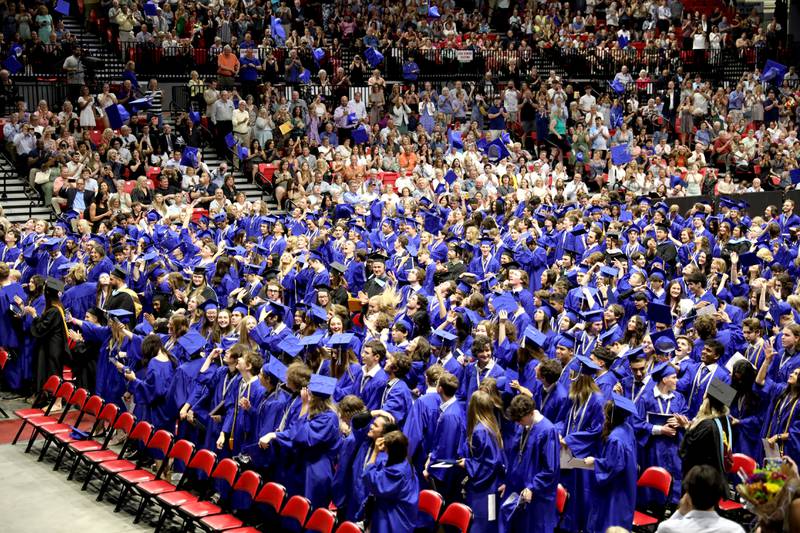 St. Charles North graduates throw their caps into the air following the school’s 2023 commencement ceremony in DeKalb on Monday, May 22, 2023.
