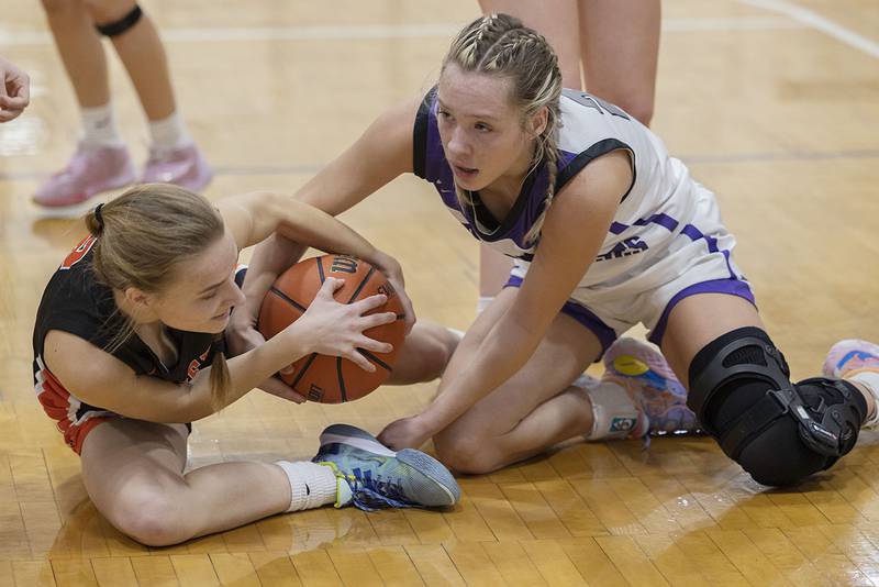 Winnebago’s Grace Erb (left) and Dixon’s Hannah Steinmeyer fight for a loose ball Monday, Jan. 9, 2023.