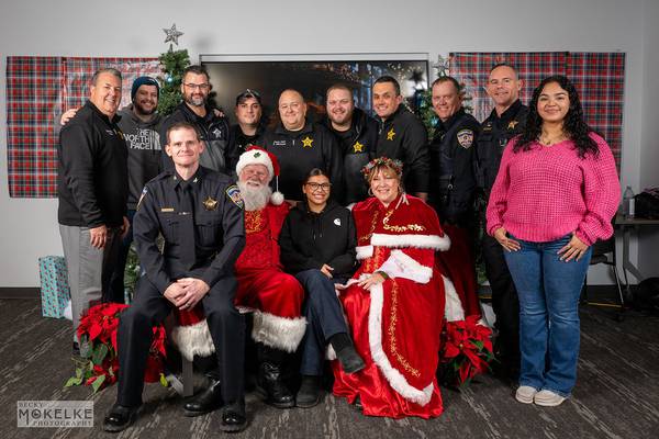 Kids open presents with Santa during the Yorkville Police Department’s annual “Shop with a Cop”