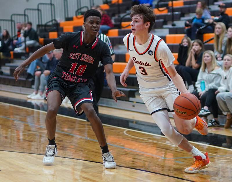 St. Charles East's Marco Klebosits (3) plays the ball on the wing against East Aurora's Davion Tidwell (10) during the 64th annual Ron Johnson Thanksgiving Basketball Tournament at St. Charles East High School on Monday, Nov 20, 2023.