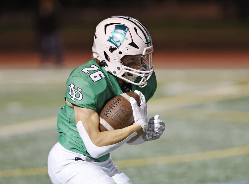 York's Henry Duda (26) runs with the ball during the varsity football game between Downers Grove North and York on Friday, Oct. 4, 2024 in Elmhurst.
