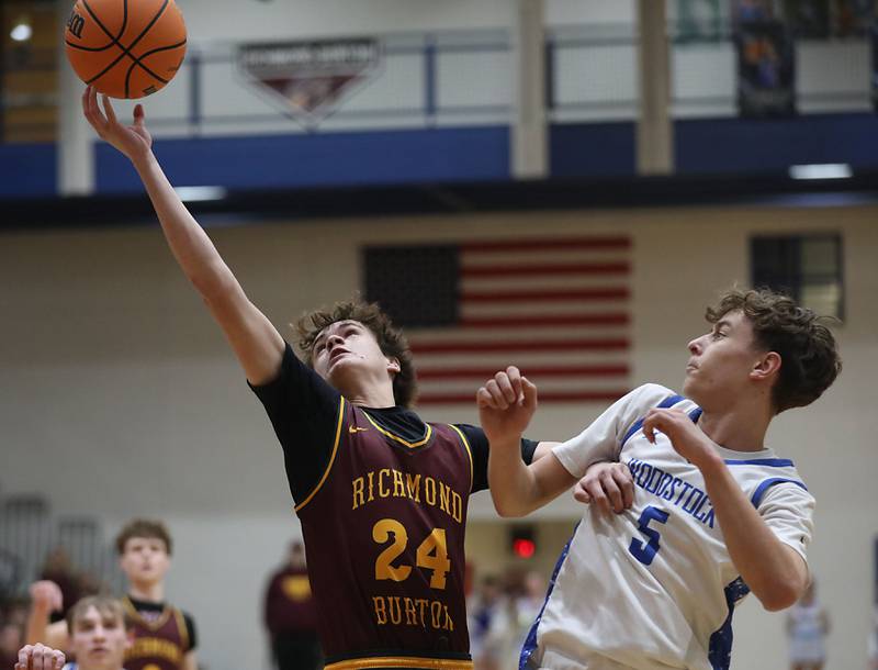 Richmond-Burton's Landon Nelson tries to grab a rebound in front of Woodstock's Max Beard during a Kishwaukee River Conference boys basketball game on Wednesday, February. 4, 2026, at Woodstock High School.
