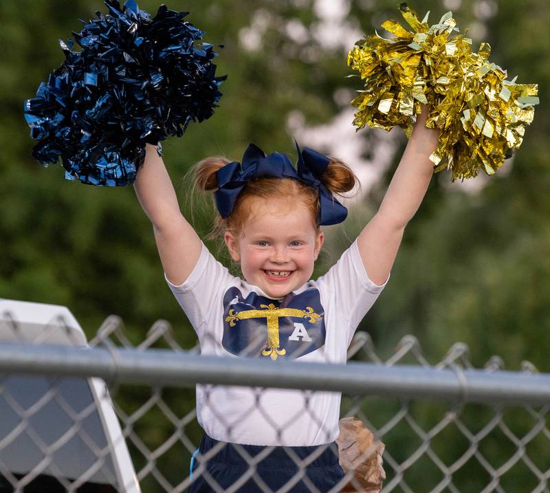 Marquette Academy second grader Kynlee Olson cheers on the Cru on Friday Aug. 26, 2022 at Gould Stadium in Ottawa.