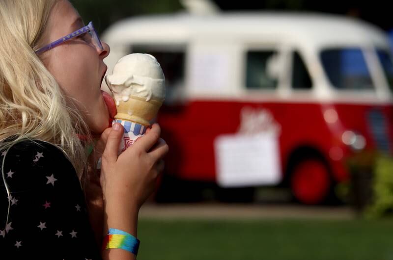Gwen Coltman, 9, of Woodstock enjoys a frozen treat Friday, Aug. 18, 2023, during Julie Ann’s first-ever Ice Cream Fest at Crystal Lake’s Main Beach.