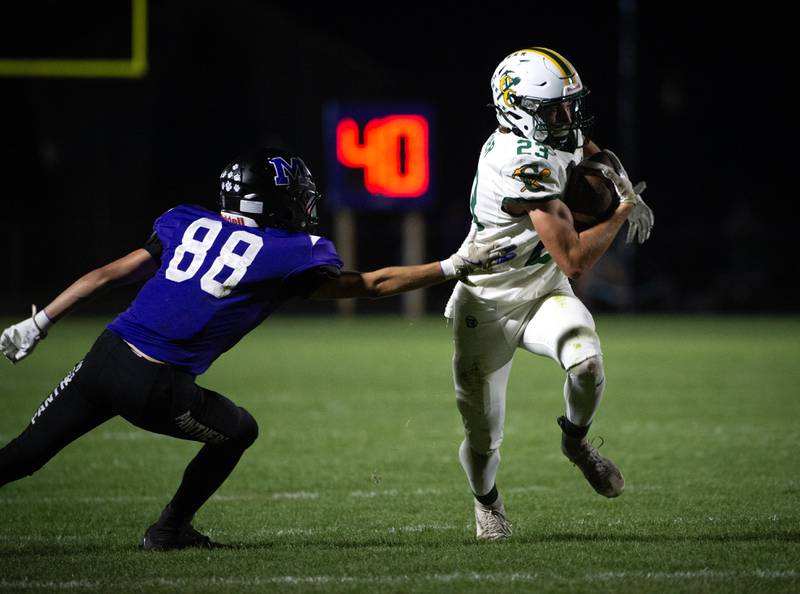 Coal City's Gavin Berger, right, carries the ball past Manteno's Jayson Gotkowski in a game on Friday, October 3, 2025.