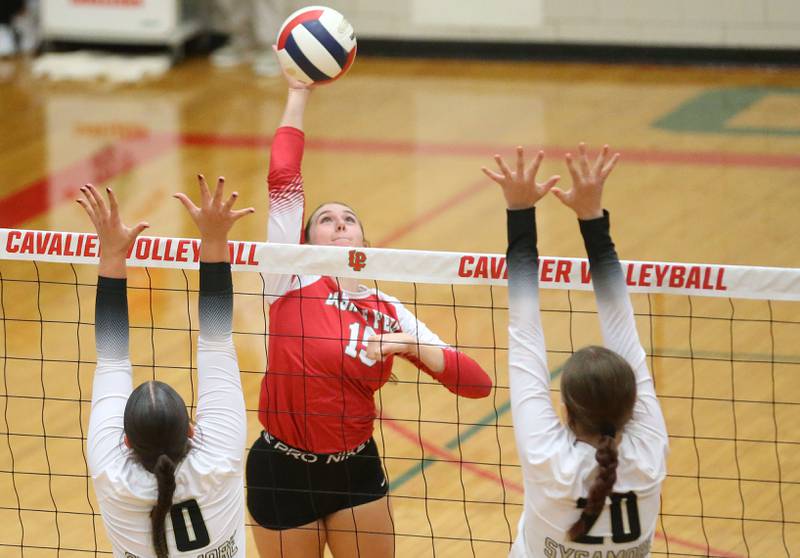 L-P's Drew Depenbrock sends a spike between Sycamore defenders Sophia Lichthardt and Ava Wente-Argo on Tuesday, Sept. 23, 2025 in Sellett Gymnasium at L-P High School.