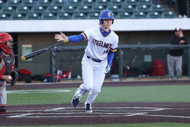 Joliet Central’s John Stasiak heads to first after drawing a walk against Aurora East on Monday, Mar. 11th in Joliet.