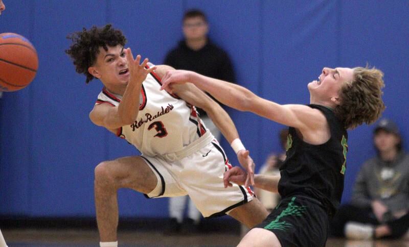 Huntley’s Lucas Crosby, left, looks for the ball as Crystal Lake South’s Carson Trivellini fires a pass away in varsity basketball tournament title game action at Johnsburg Friday.