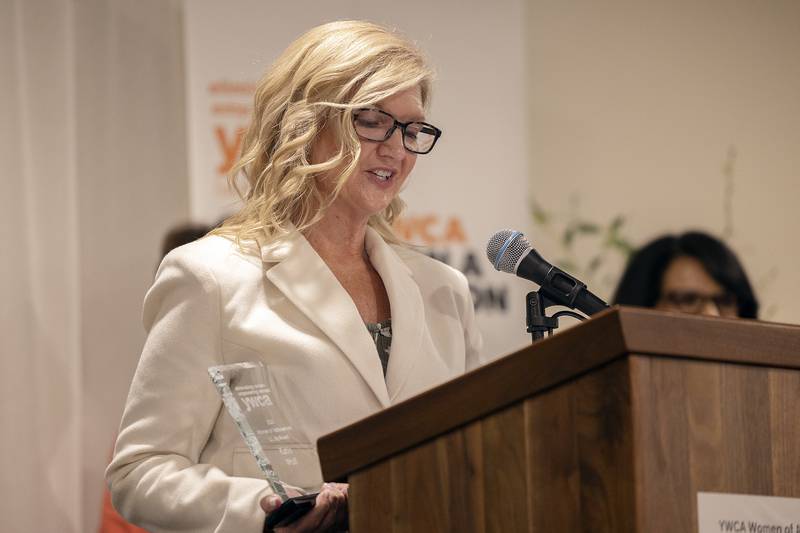 Liz Foster, representing CGH Medical Center, awards Katie Wolfe with the L.L Ely Award for Clerical Excellence Thursday, April 17, 2025, during the YWCA’s Women of Achievement Luncheon.