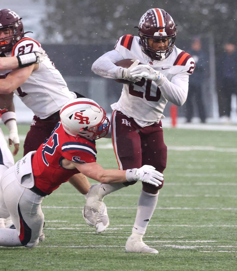 Brother Rice's Jaylin Green tries to break free from St. Rita's Kyle Keyser Wednesday, Dec. 3, 2025, during their IHSA Class 7A state chamionship game in Huskie Stadium at Northern Illinois University in DeKalb.