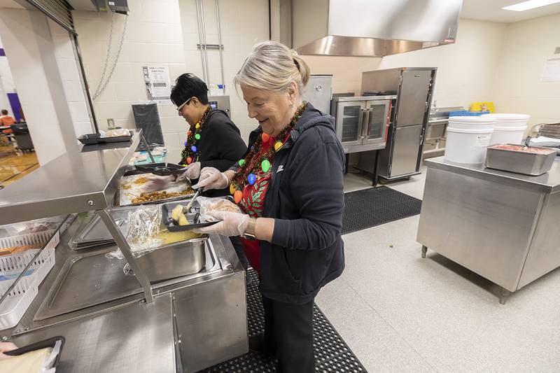 Priscilla Smith (left) and Sheila Brady serve lunches Tuesday, Dec. 17, 2024, at Jefferson School in Dixon. Destiny McElhinney of Dixon is leading a fundraiser with the goal of wiping out student lunch debt at the school.