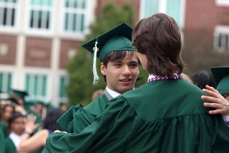 Alex Michael greets classmates as they prepare for graduation at York High School in Elmhurst on Sunday, May 18, 2025.