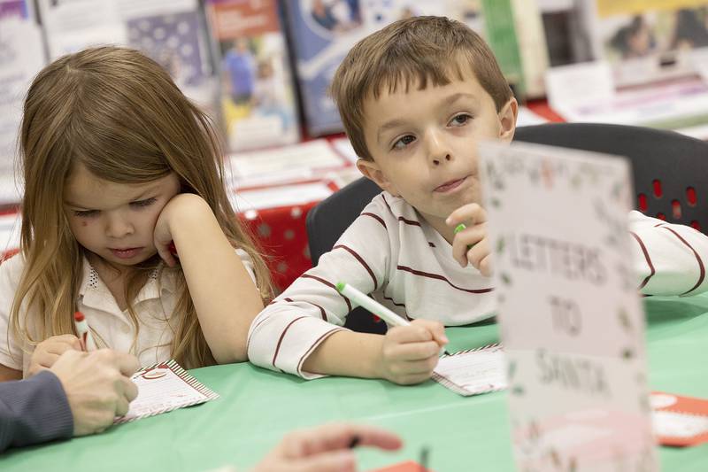 Declan Clark (right), 6, contemplates his letter to Santa with sister Ellie, 4, Wednesday, Dec. 11, 2024, during Whiteside County Senior Center’s Sandwiches with Santa event.