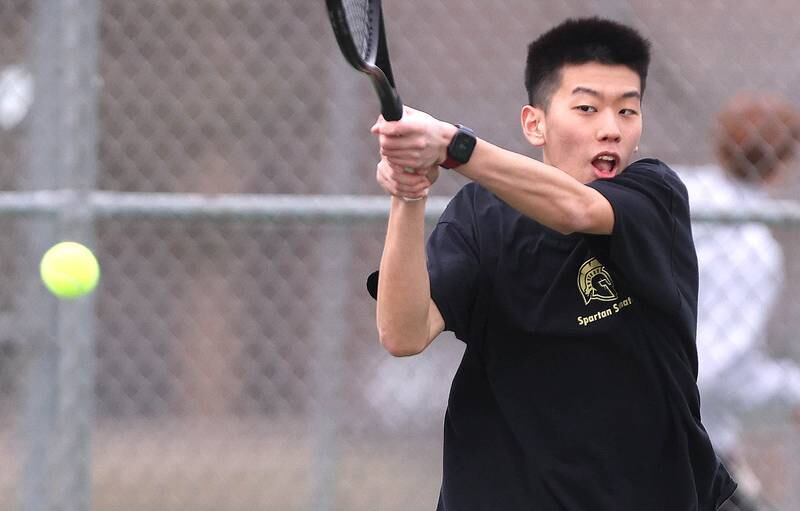 Sycamore’s number one singles player Steven Chen follows through on a backhand during his match against Dixon Thursday, March 30, 2023, at Sycamore High School. This is the inaugural season for the Sycamore boys tennis team.