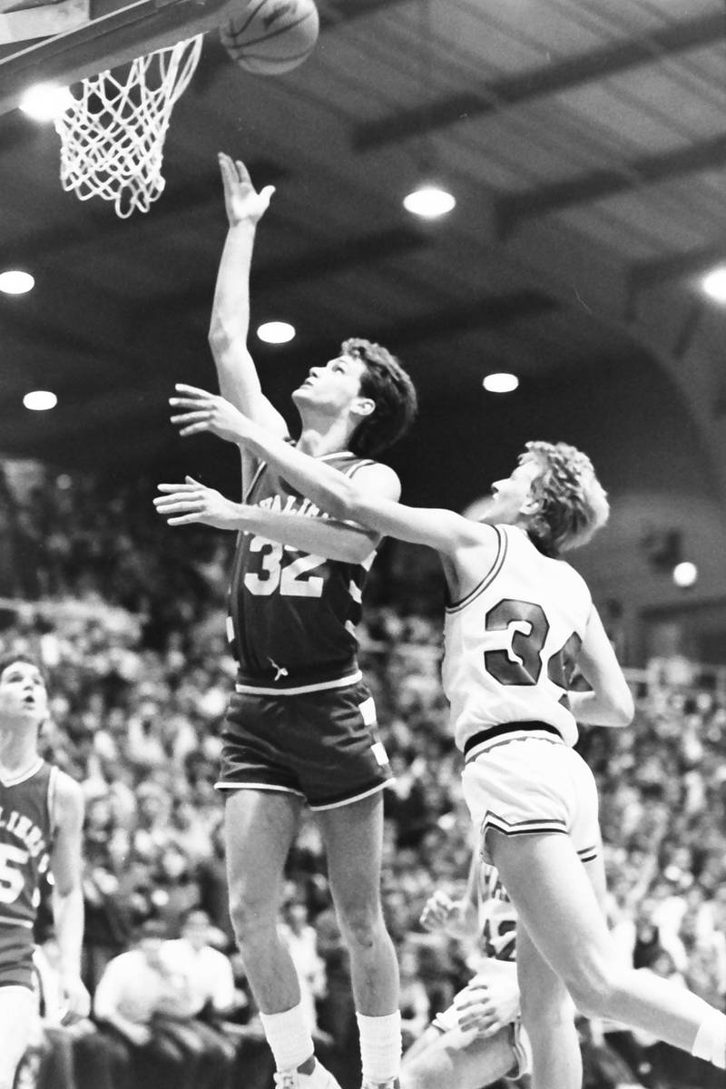 L-P's John Happ lets go of a shot underneath the hoop over Ottawa's Dave Yell during the Regional title game on Saturday, Feb. 28, 1986 at La Salle-Peru Township High School.