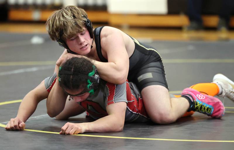 Sycamore’s Douglas Gemberling controls Ottawa’s Malikhai Stayton during their 157 pound match Thursday, Dec. 14, 2023, at Sycamore High School.