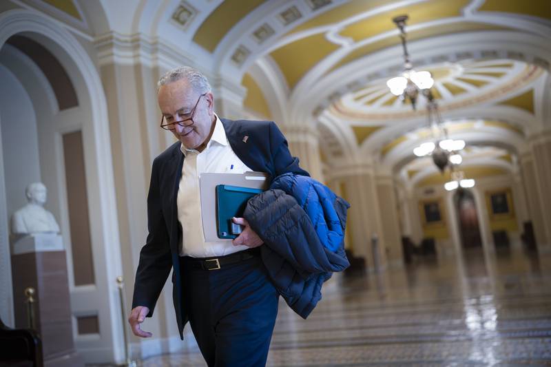 Senate Majority Leader Chuck Schumer, D-N.Y., arrives as the Senate prepares to take a procedural vote on an emergency spending package that would provide military aid to Ukraine and Israel, replenish U.S. weapons systems and provide food, water and other humanitarian aid to civilians in Gaza, at the Capitol in Washington, Sunday, Feb. 11, 2024. (AP Photo/J. Scott Applewhite)