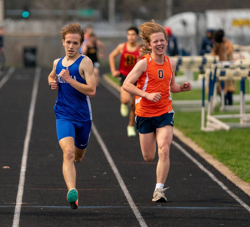 Geneva’s Andrew Warcup (left) wins the 3200 meter run during the Roger Wilcox Track and Field Invitational at Oswego High School on Friday, April 29, 2022.