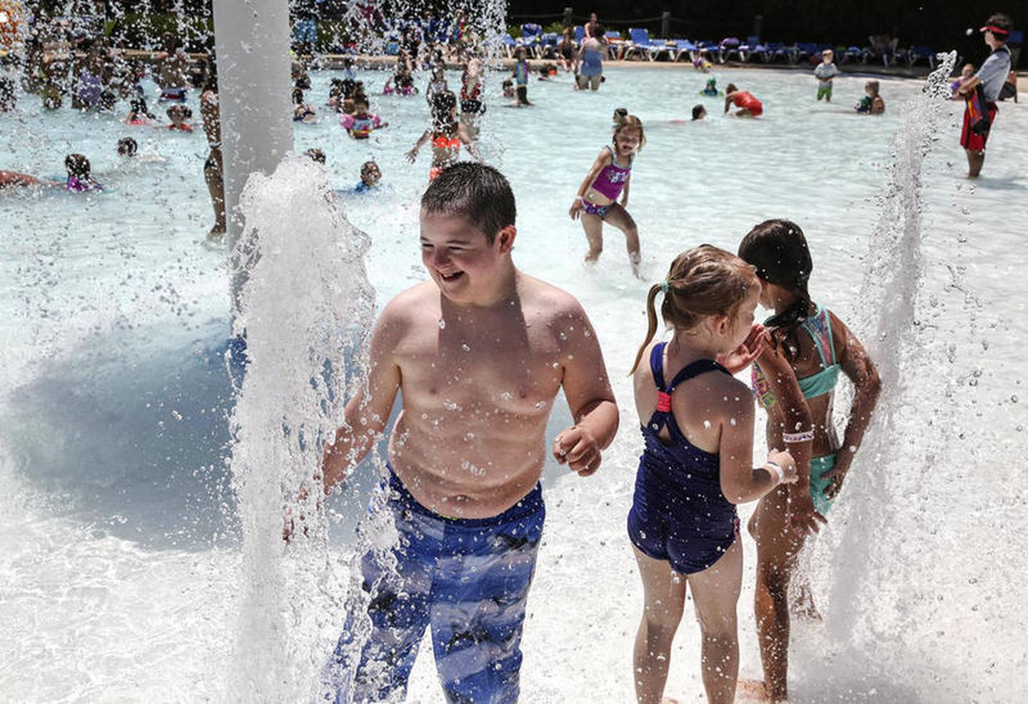 Several hundred people cool off in the water Tuesday, June 11, 2019, at Tomahawk Aquatic Center in Channahon, Ill.