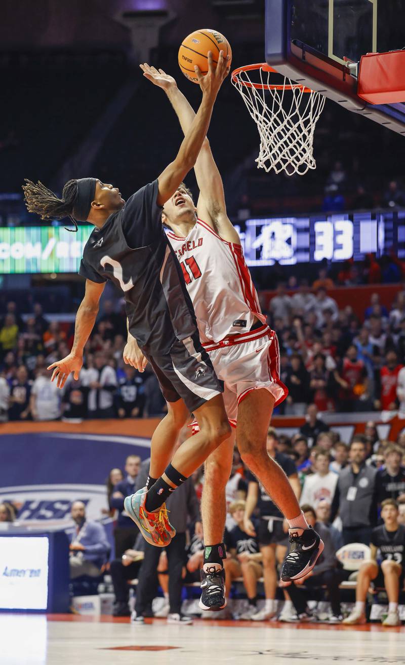 Kaneland's Isaiah Gipson (2) drives to the hoop past Deerfield's Jake Pollack (11) during the IHSA Class 3A boys basketball state semifinal Friday, March 13, 2026 at the State Farm Center in Champaign.