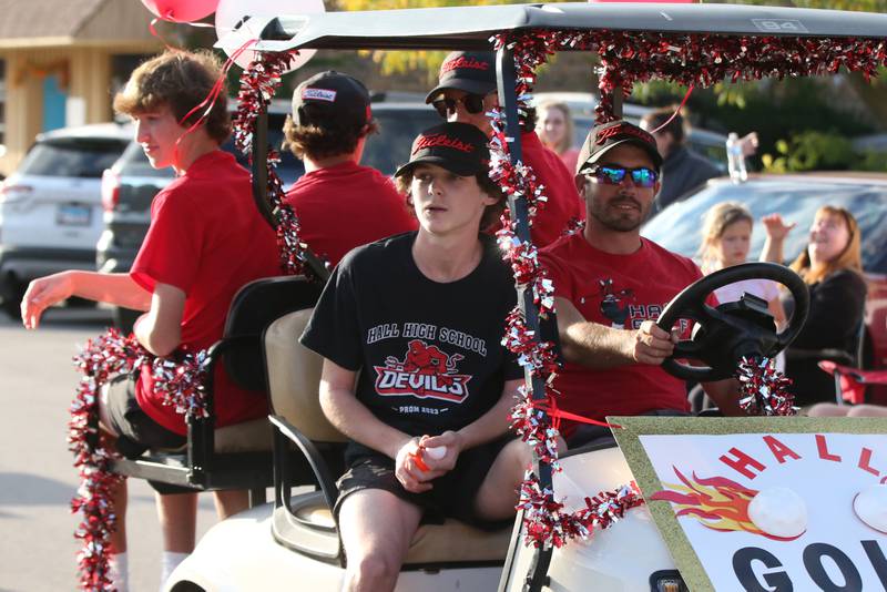 Members of the Hall High School golf team ride a float during the Homecoming parade on Thursday, Sept. 28, 2023 in Spring Valley.