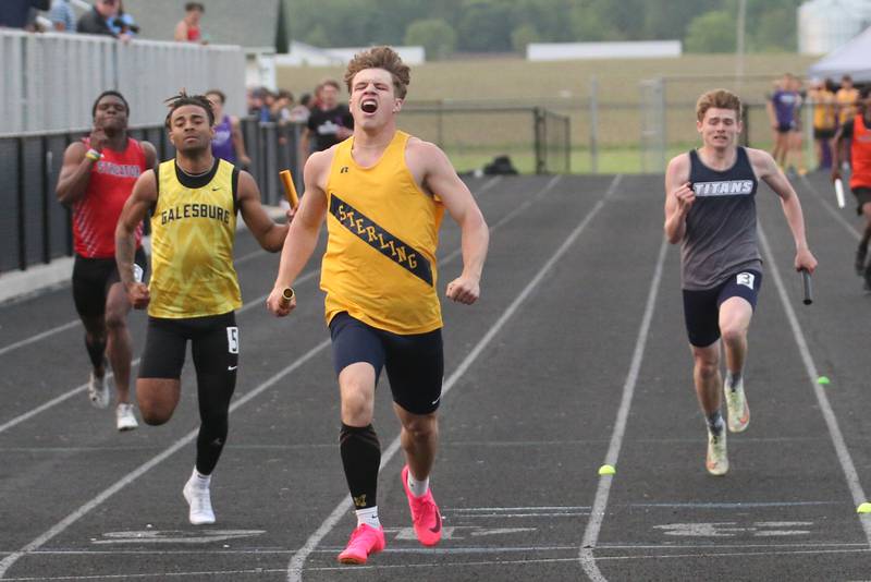 Sterling's Kael Ryan (center) reacts after winning the 4x200 meter relay during the Class 2A track sectional meet on Wednesday, May 17, 2023 at Geneseo High School.