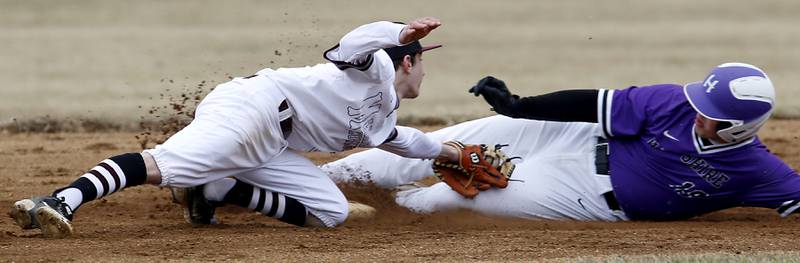Marengo's Patrick Signore reachs to try and tag Hampshire's Luke Mejdrich as he slides into second base during a non-conference baseball game Wednesday, March 30, 2022, between Marengo and Hampshire at Marengo High School.
