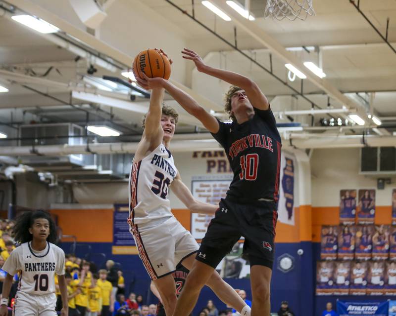 Oswego's Brayden Borrowman (30) blocks the shot of Yorkville's Graham Martinson (10) during their basketball game between Yorkville at Oswego, Feb 7, 2026 in Oswego.