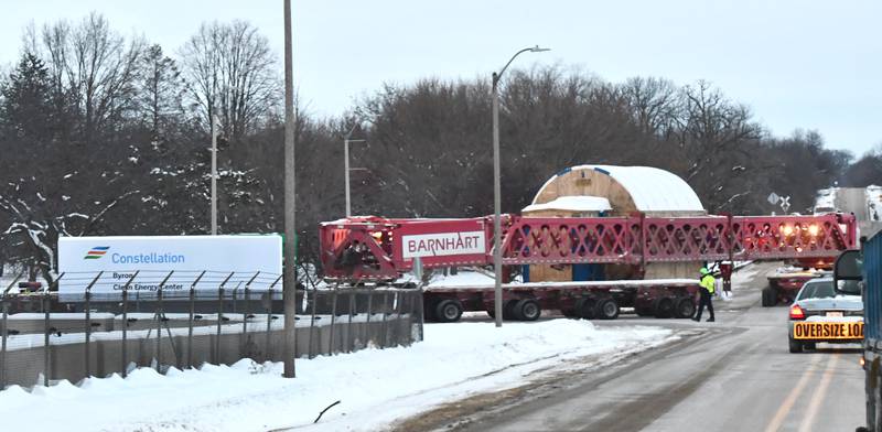 The tractor and trailer pulling and pushing one of the large turbines turns in at the main entrance for Constellation's Byron generating station on Monday, Dec. 8, 2025.