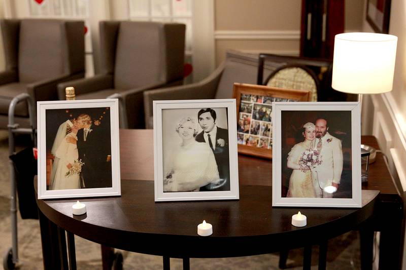 Wedding pictures of (from left)  Sherri and William Bowne, Richard and Christine Garcia and Marcia Whitney-Schenck and Robert Schenck are displayed before the three couples renewed their vows on Friday, Feb. 14, 2025 at Churchill Place, an Anthem Memory Care community in Glen Ellyn.