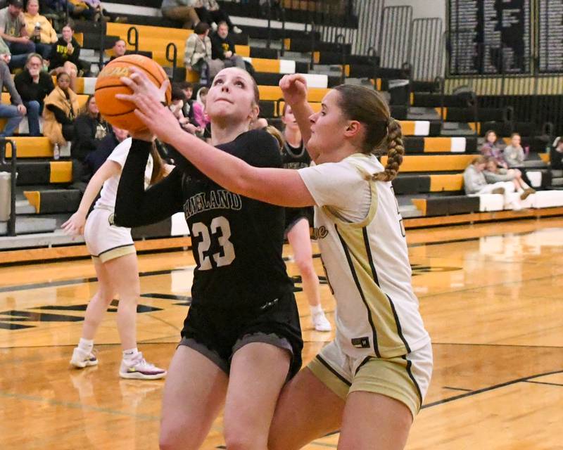 Kaneland's Kendra Brown (23) shoots the ball while being defended by Sycamore's Grace Amptmann (5) during the game on Monday Feb. 10, 2025, held at Sycamore High School.