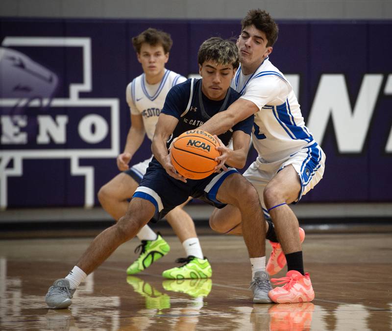 Peotone's Tyler Walker, right, attempts to knock the ball loose from IC Catholic's Gael Mendoza, left, in the Thanksgiving tournament at Manteno High School on Monday, November 24, 2025.