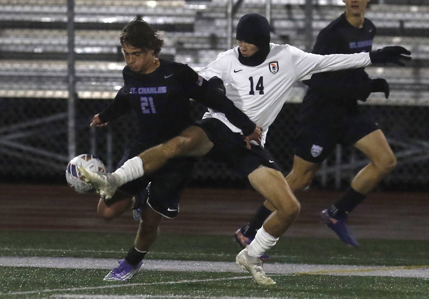 McHenry's Kyren Rivard (right) kicks the ball away from St. Charles North's Vincent Garbato during an IHSA Class 3A Huntley Regional boys soccer semifinal match on Tuesday, Oct. 21, 2025, at Huntley High School.