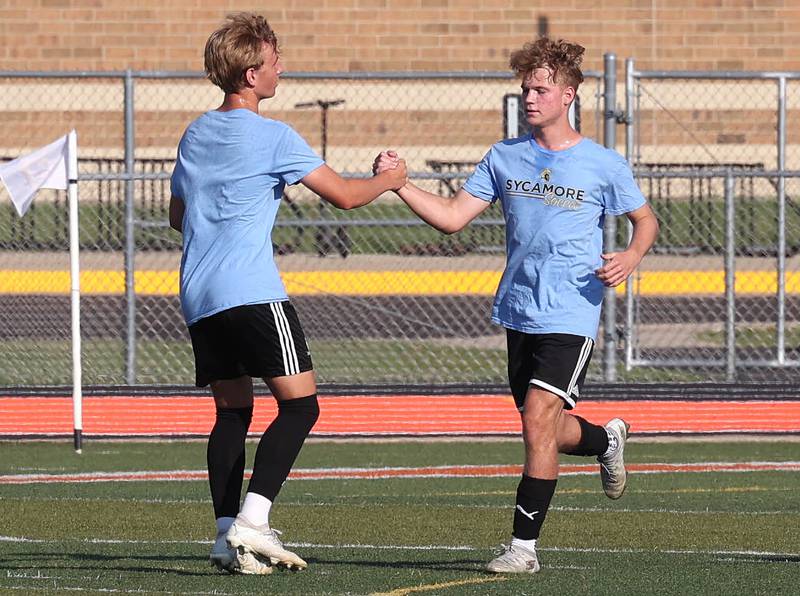 Sycamore’s Aiden Sears (right) is congratulated after scoring a goal Monday, July 14, 2025, during a summer boys soccer friendly at DeKalb High School.