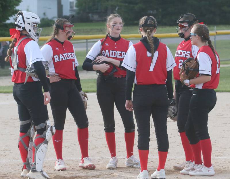 Members of the Earlville softball team chat on the mound while playing Newark during the Class 1A Regional final on Thursday, May 22, 2025 at Indian Creek High School in Shabbona.
